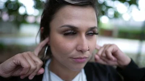Stubborn person avoiding commentary putting finger inside ear not wanting to  Foto stock