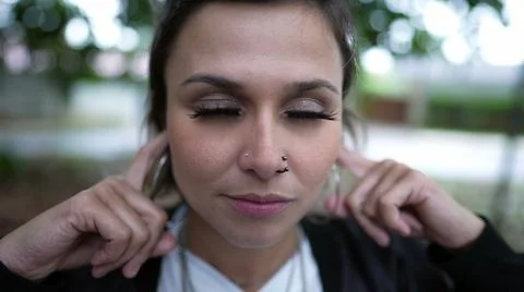 Stubborn person avoiding commentary putting finger inside ear not wanting to  Foto stock