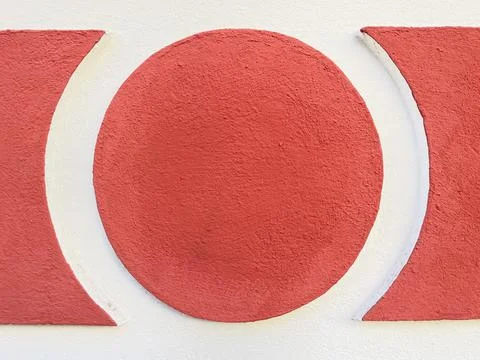 Stucco circle or round frame textured wall background in red and white Stock Photos