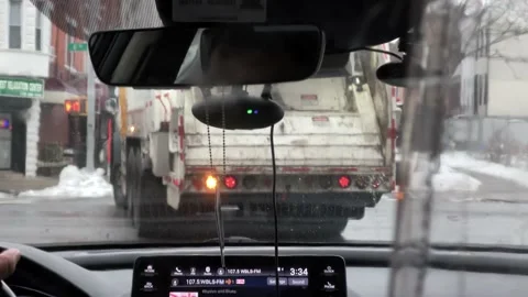 Stuck driving behind slow moving trucks garbage truck UPS winter Brooklyn NYC 库存影片 148344545