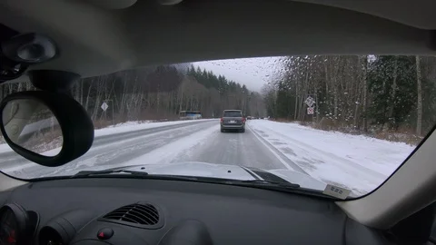 Stuck in slow traffic driving on snowy highway road. Stock Footage 102351908