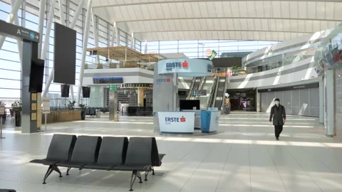 Stuck Tourist Walking Across Empty Airport Departure Hall During Covid19 Stock Footage 130277370