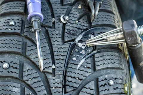 Stud installer tool for precise placement in tire hole Stock Photos
