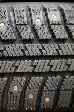 Studded tire on a background close-up Stock Photos