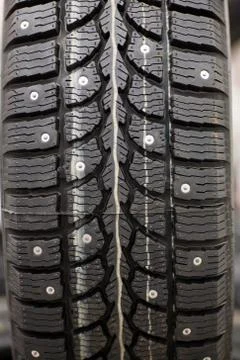 Studded tire on a background close-up Stock Photos