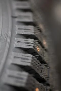 Studded tire on a background close-up Stock Photos