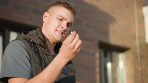 Student about to smoke changes mind and throws cigarette away Stock Footage 307066609