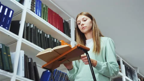 Student Absorbed in Reading at Library Stand Stock Footage 263190836