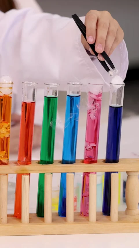 Student Adding Dry Ice into Colorful Liquid Test Tubes Stock Footage 346276269