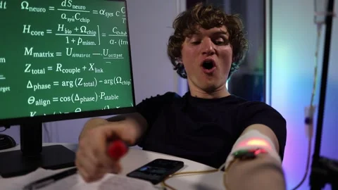 Student adjusts wearable device during intense biohacking test Stock Footage 324444054