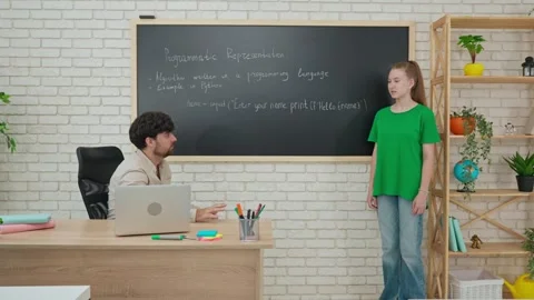 Student and Instructor Discuss Python Code in Modern Classroom Stock Footage 281072153