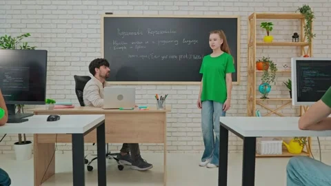 Student and Instructor Discuss Python Code in Modern Classroom Stock Footage 281072309