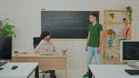 Student and Instructor Discuss Python Code in Modern Classroom Stock Footage 281072351