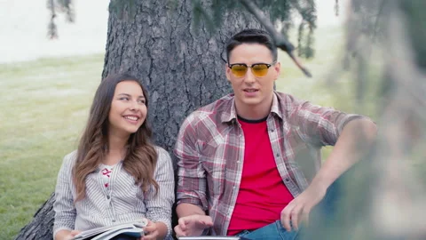 The student and the student communicate in between classes. The guy's talking to Stock Footage 138998876