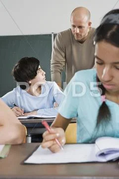 A student and a teacher in a classroom Stock Photos