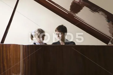 Student And Teacher Playing Piano Stock Photos