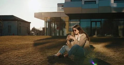 Student and technologies. Pretty young woman reads something in her smartphone Stock Footage 106445421