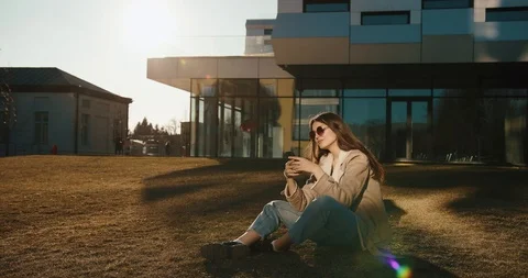 Student and technologies. Pretty young woman reads something in her smartphone Stock Footage 106462268