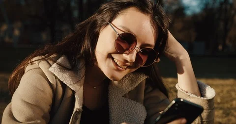 Student and technologies. Pretty young woman types something in her smartphone Stock Footage 106462795