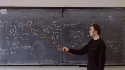 Student answers near the blackboard with a pointer Stock Footage 75757898