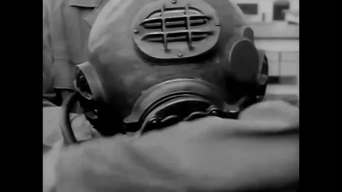 A student Army diver lowers himself down a descending line into a tank of water Stock Footage 79514253