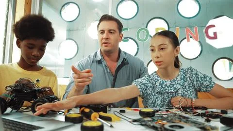Student asking teacher about code and pointing at laptop screen. Edification. Stock Photos