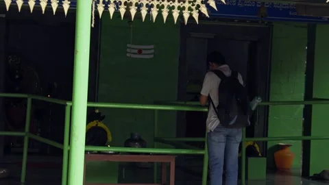 Student with a backpack worshipping and praying to God with devotion at templ Stock-Footage 243652425