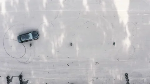 Student on a black car bypasses obstacles. slalom by car between tires. Video stock 144822296