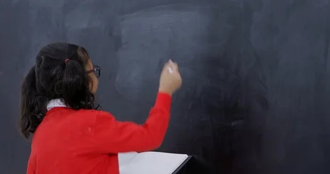 Student with book writes a math problem Vídeos de archivo 86991815