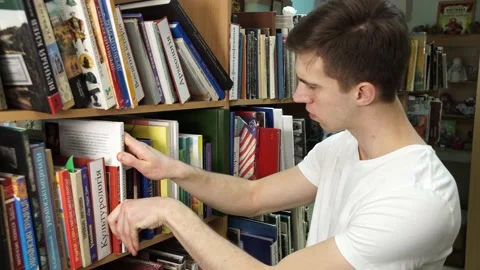 Student at the bookshelf Stock Footage 155962863