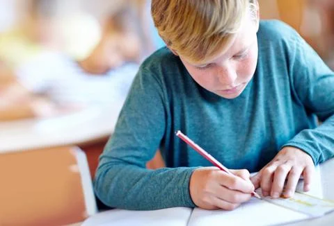 Student, boy and drawing for learning in classroom, book and problem solving at 写真素材