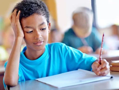 Student, boy and writing notes for studying in classroom, book and problem Stock Photos