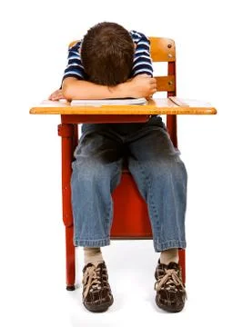 Student: boy with head on desk Stock Photos