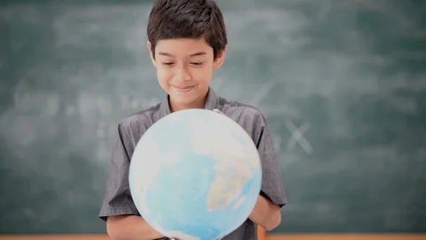 Student boy learning geography earth map in the classroom Stockbeeldmateriaal 105207965