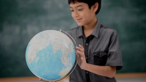 Student boy learning geography earth map in the classroom Stockbeeldmateriaal 105207974