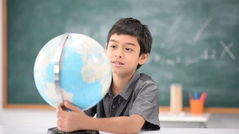 Student boy learning geography earth map in the classroom Stockbeeldmateriaal 105207994