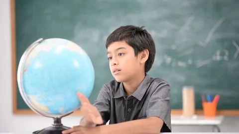 Student boy learning geography earth map in the classroom Stockbeeldmateriaal 105207996