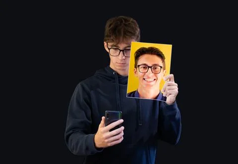 Student boy showing a different face on social network. Fake positive image i Stock Photos