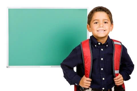 Student: boy standing in front of blank chalkboard Stock Photos