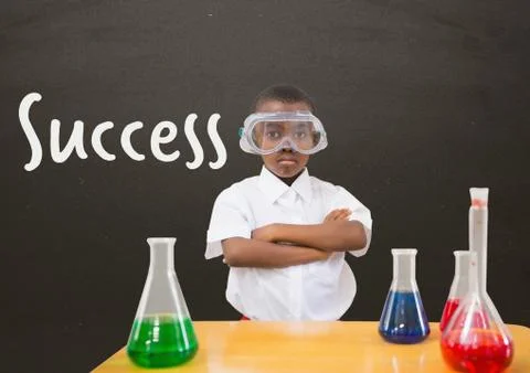 Student boy at table against grey blackboard with success text Stock Photos