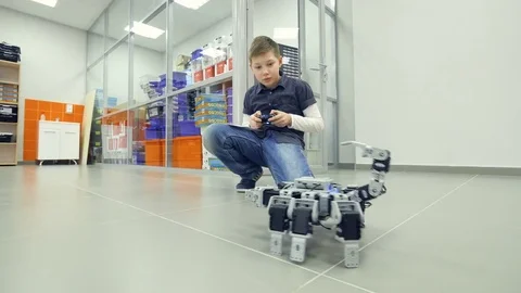 Student boy testing robot in robotechnics school classroom. Engineer education Stock Footage 74195087