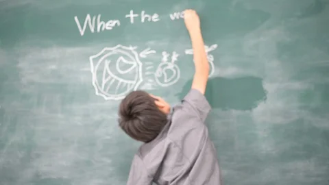 Student boy writing on the board about earth day save the world Stockbeeldmateriaal 105206663