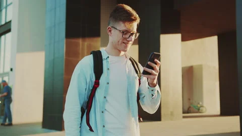 Student browsing internet, portrait of young man in casual jeans, white t-shirt Stock Footage 141557189