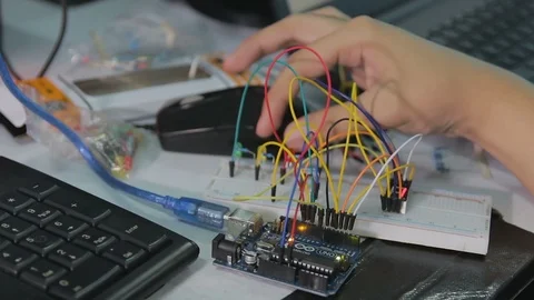 Student building a mini traffic lights Stock Footage 87690762