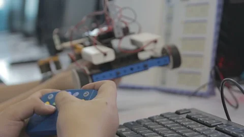 Student building a robot vehicle Stock Footage 87701458