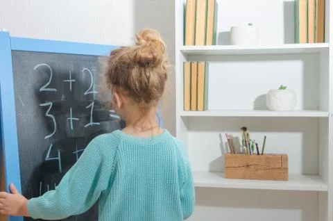 The student on the chalk Board decides examples 写真素材