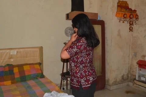 Student Changing Into Patterned School Uniform Inside Her Bedroom Stock Photos