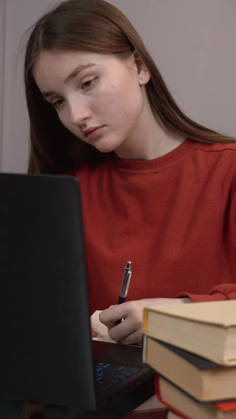 Student changing posture while studying at home Stock Footage 311806943