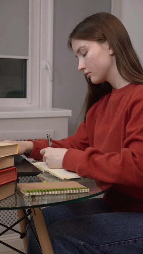 Student changing posture while studying at home Видео 311808082