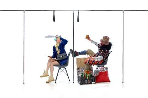 Student chases away while homeless man lifts foot on seat, eating bread against Stock Photos